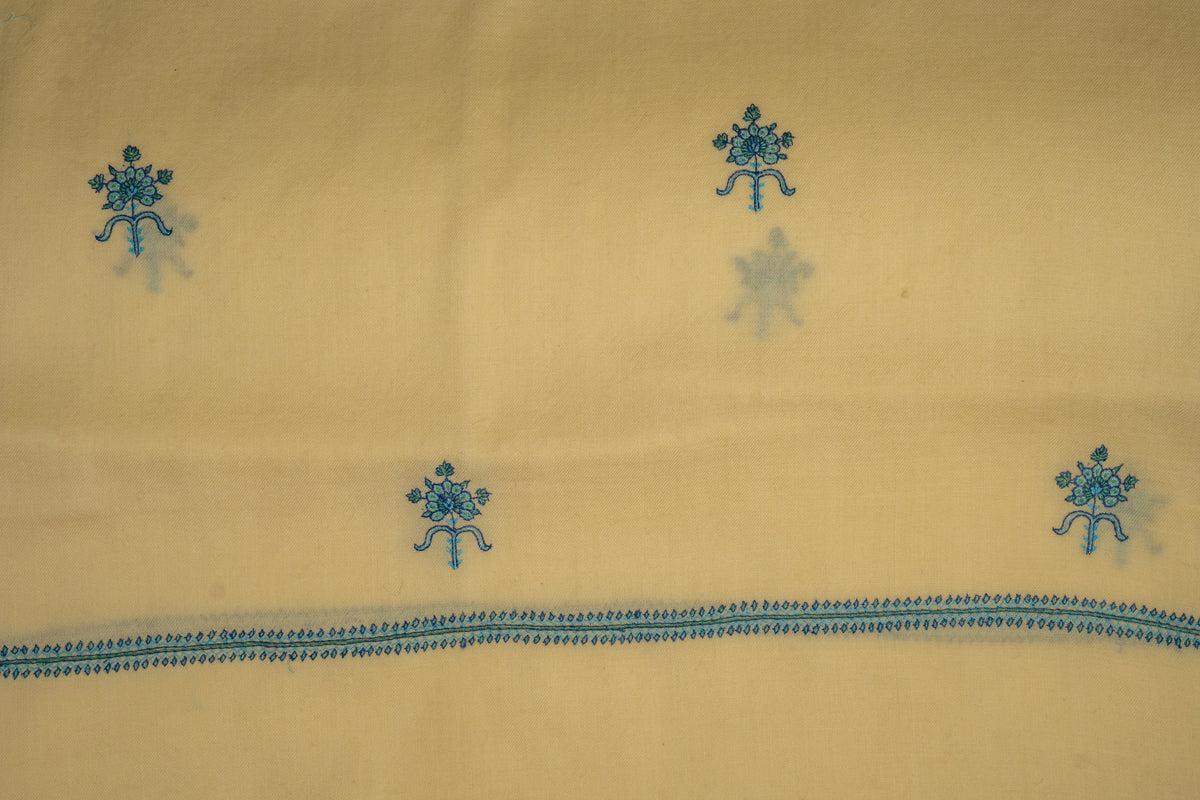 Buttercream stole laid flat, showing scattered teal flower motifs above a narrow embroidered end border.
