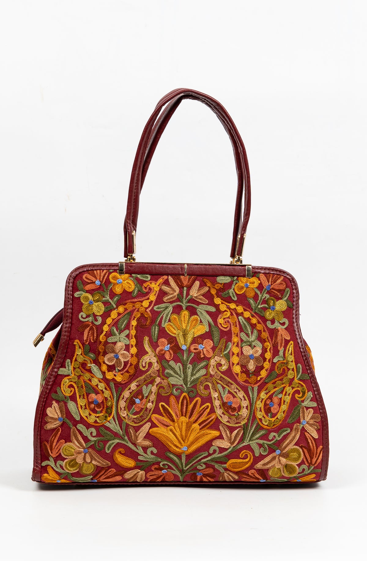 Front view of a maroon double-handle handbag with symmetrical golden Aari flowers, green leaves and multicoloured paisleys