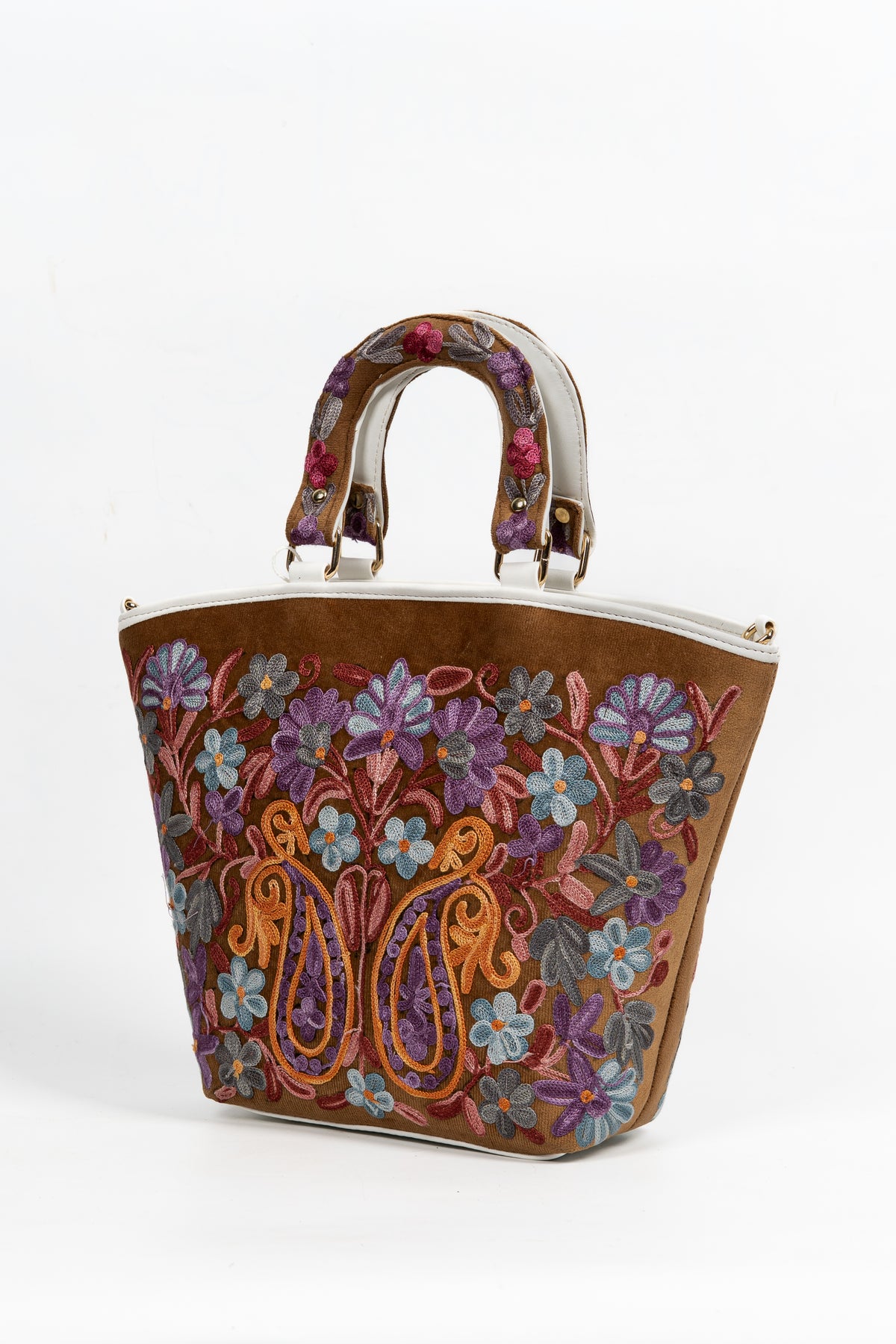 Angled view of the brown tote with colourful Aari flowers and paired golden paisleys across the front.