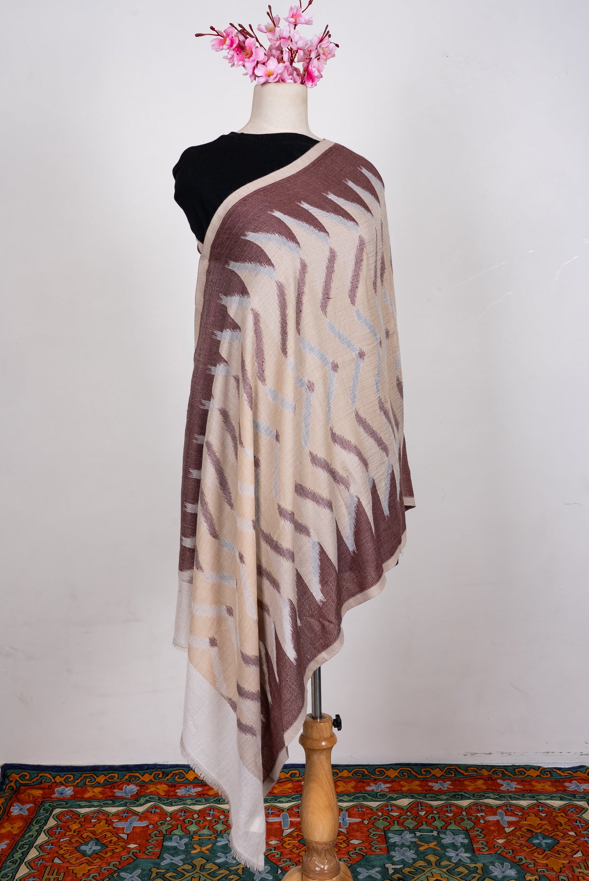 Full view of the beige and mocha Merino wool scarf on a mannequin, with a large abstract zigzag pattern and pale end panels
