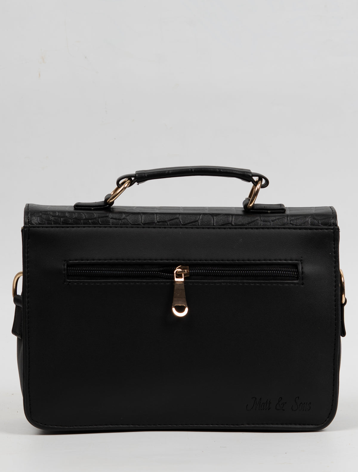Plain black back of the handbag, with a horizontal zip pocket, gold-toned pull and short top handle