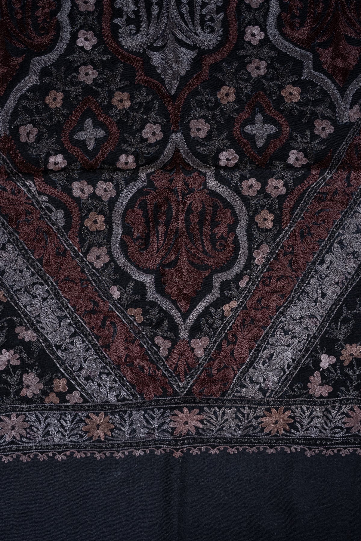 Close-up of the triangular paisley panel on black shawl, framed by silver and muted-rose embroidered borders