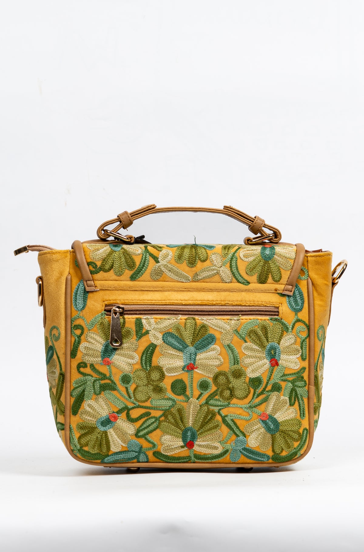 Straight-on rear view of the mustard floral bag, with a zip pocket above symmetrical green and pale blue flowers.