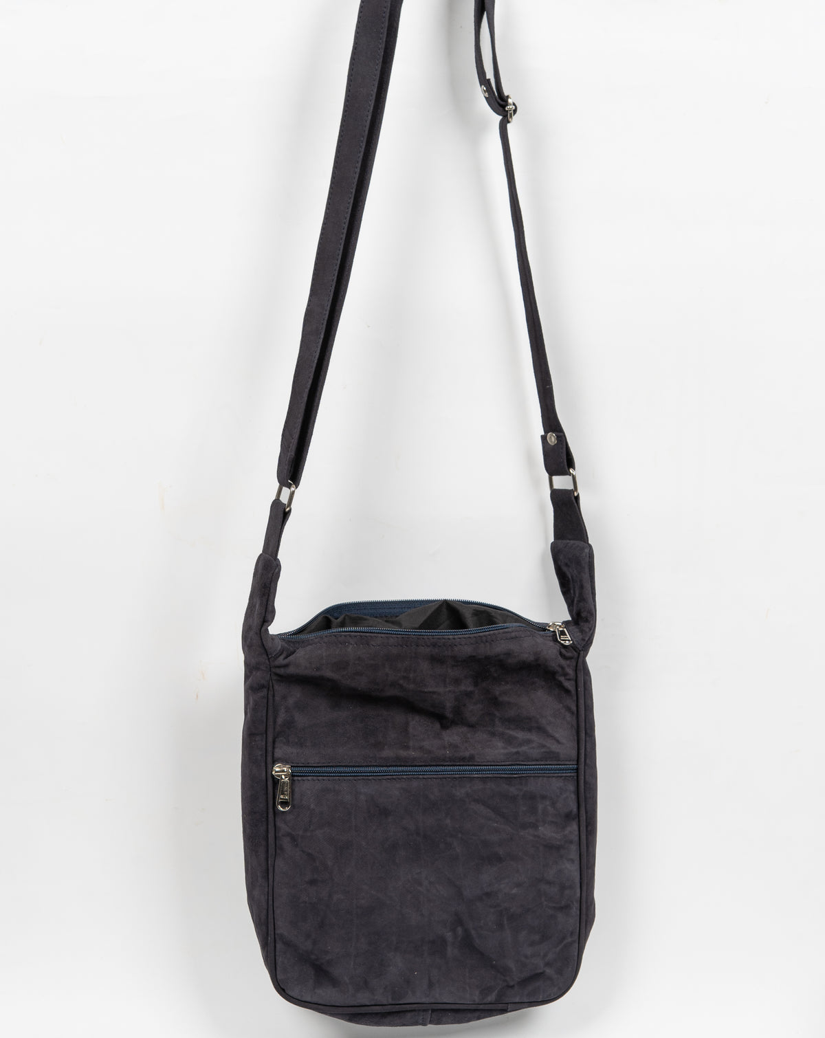 Back view of the black messenger bag showing a plain textured panel, horizontal zip pocket and long adjustable strap.