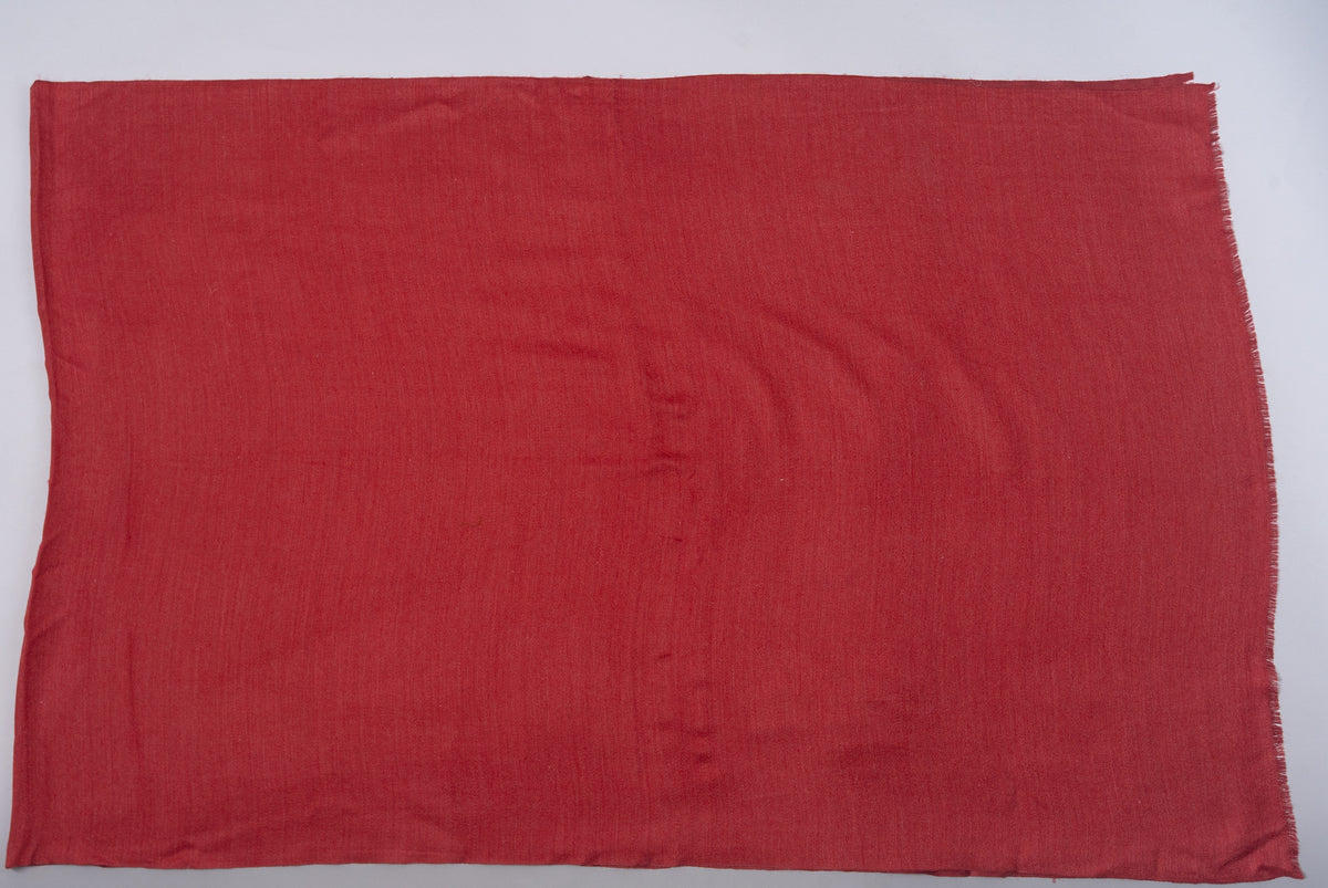 Plain crimson Merino wool stole spread flat, showing its rectangular shape and lightly fringed ends