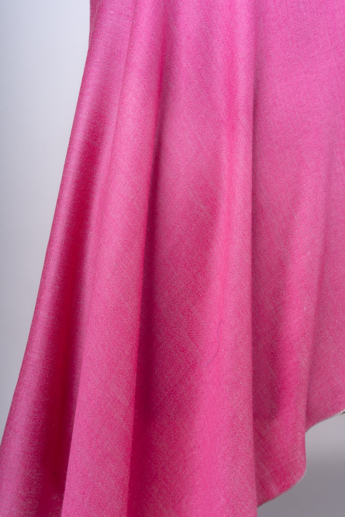 Detail of the candy-pink stole’s hanging folds and fine woven texture