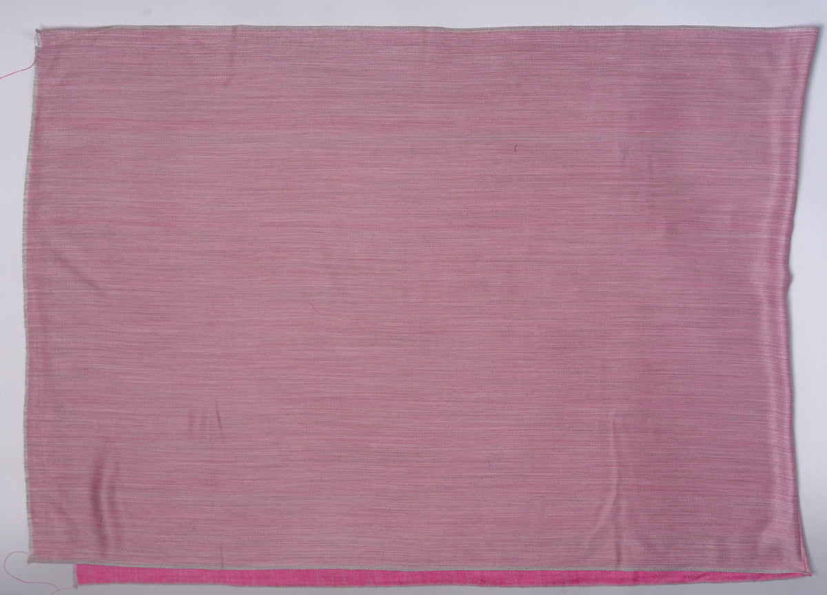 Dusty-rose side of the reversible stole laid flat, with a narrow candy-pink edge showing beneath