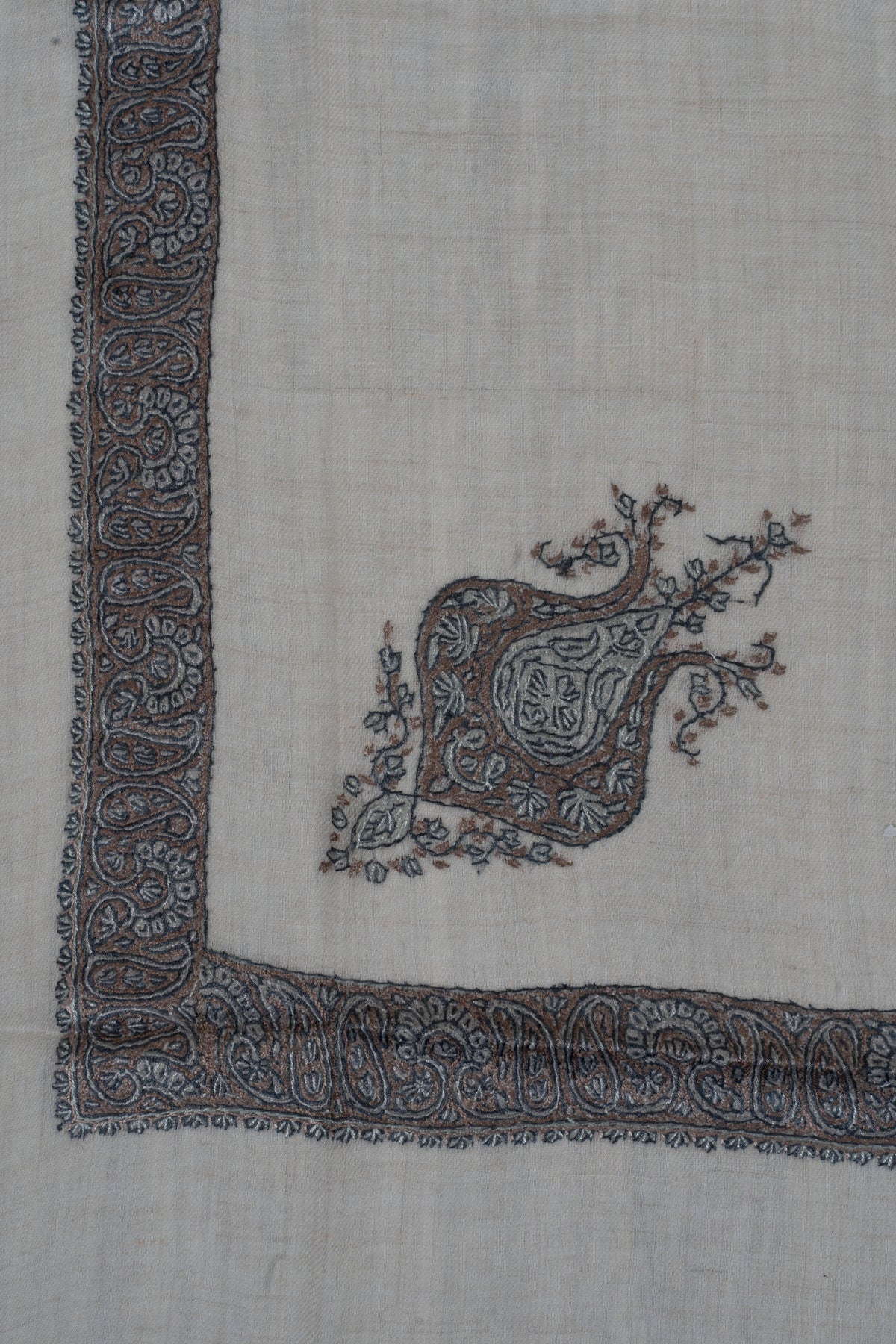 Cream rumal corner with a grey-blue Sozni paisley border and a matching ornate floral motif