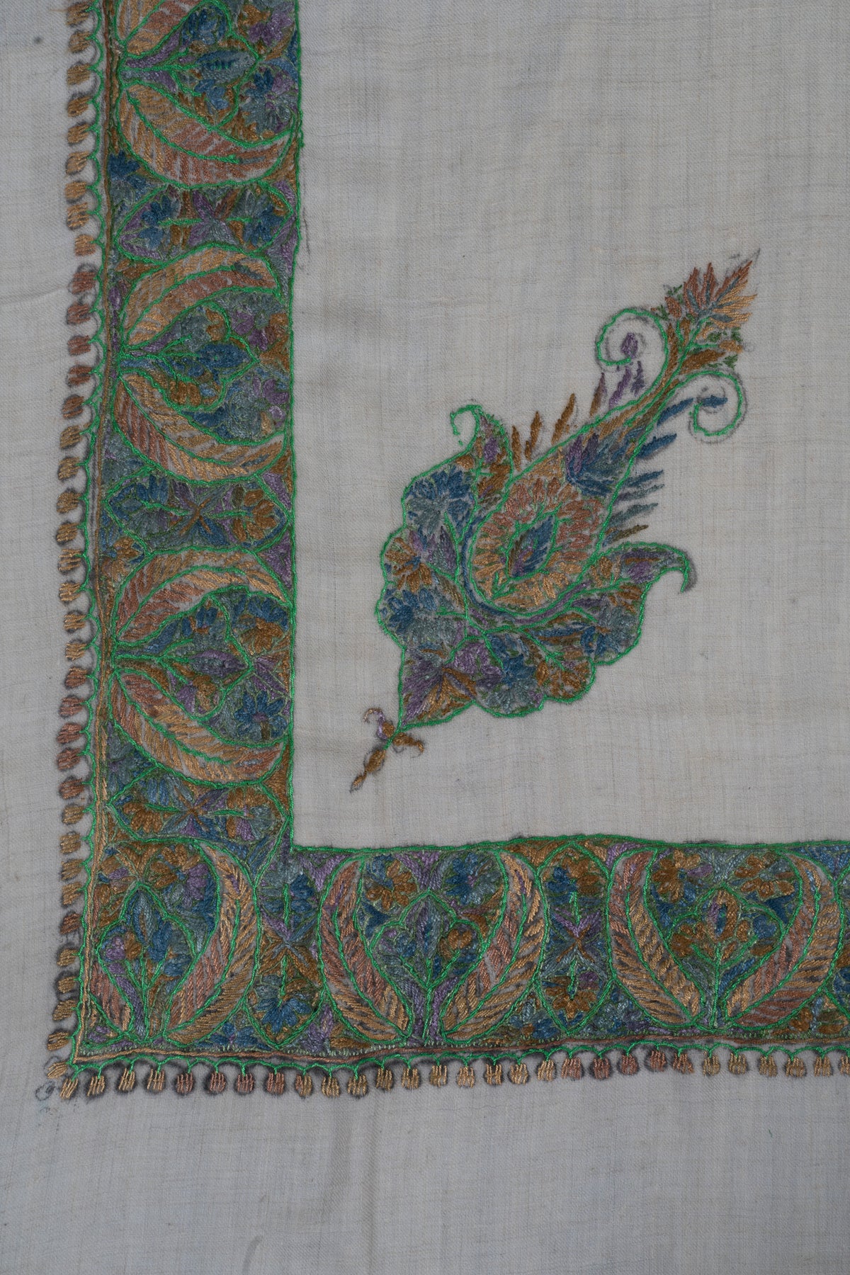Ivory rumal corner with green leaf borders and a smaller blue-green floral motif