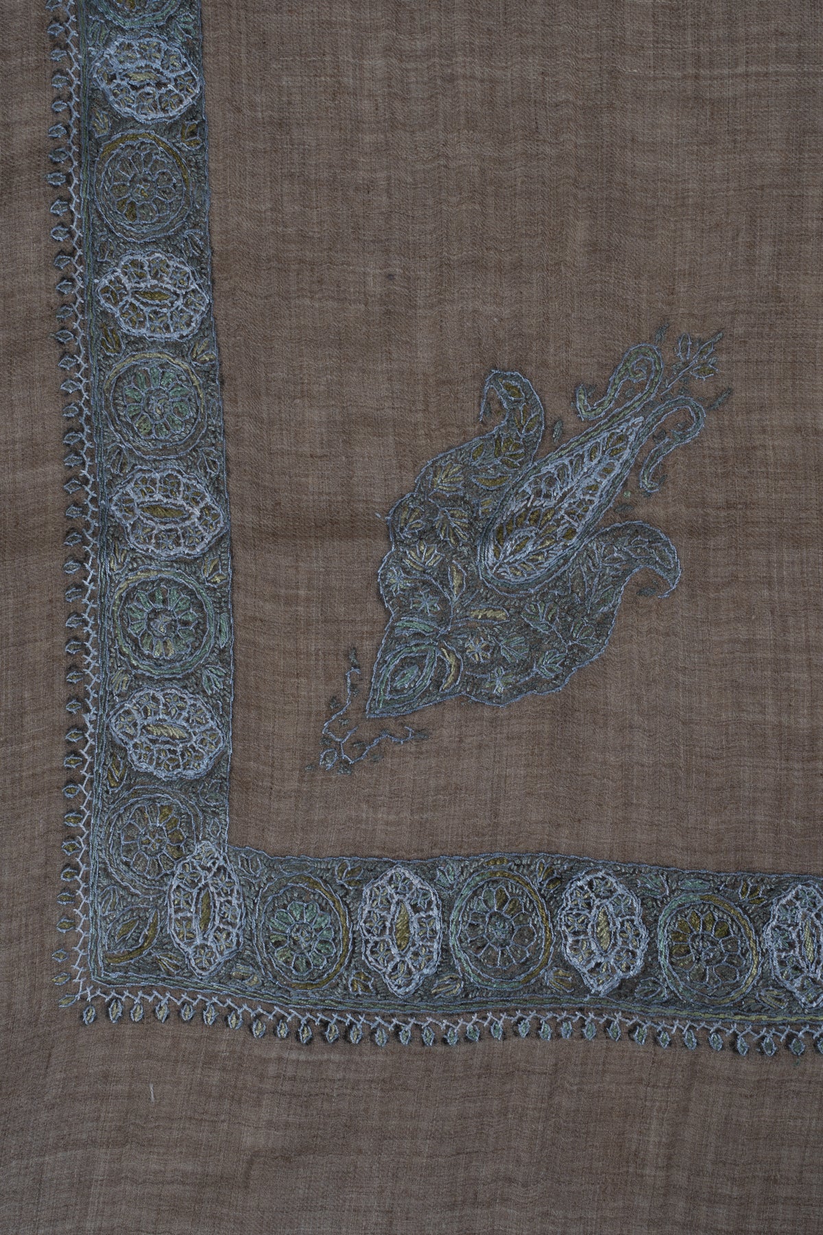 Corner of a mushroom-brown cashmere rumal with a blue-grey Sozni paisley and matching medallion borders.