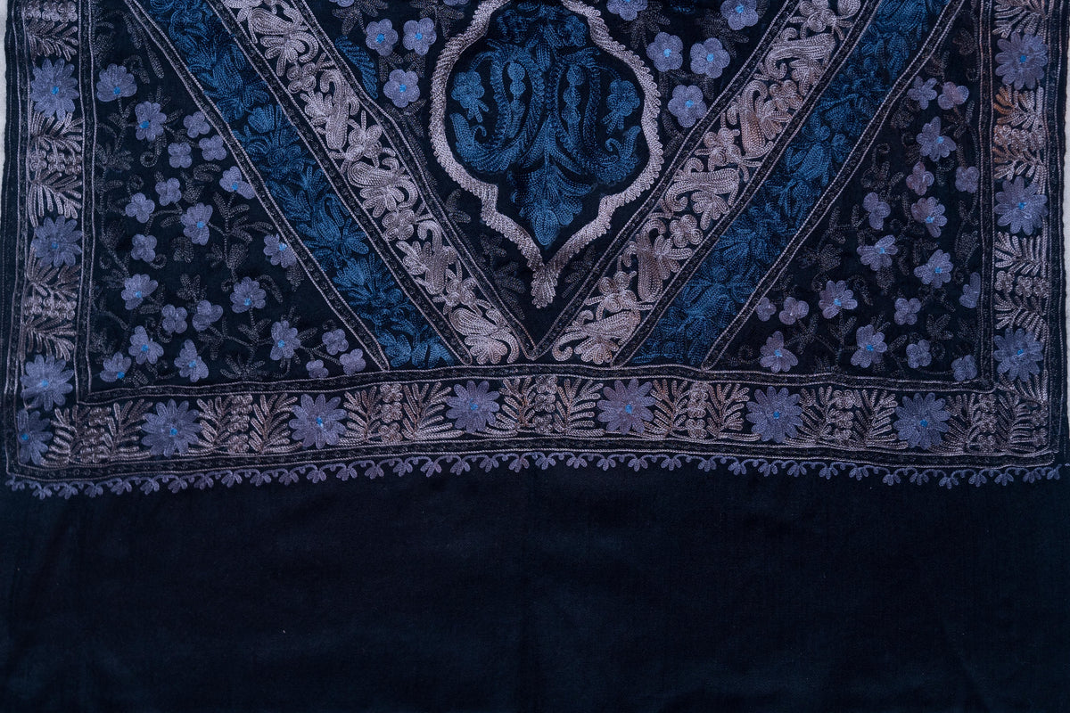 Black stole end with a pointed blue floral panel, silver-toned leaf borders and a plain lower section