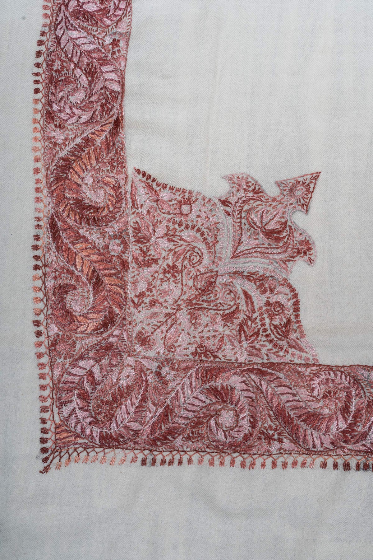 Ivory rumal corner with a dense dusty-rose paisley panel extending into a pointed floral design
