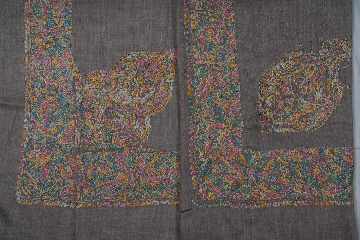 Two charcoal Merino wool rumal corners comparing a large leafy Sozni corner with a separate ornate motif inside the border.