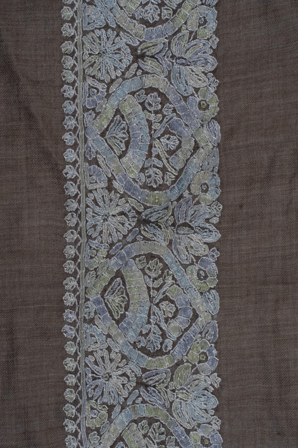 Pale blue-grey Sozni curved medallions and flowers with subtle sage accents along a broad taupe rumal border