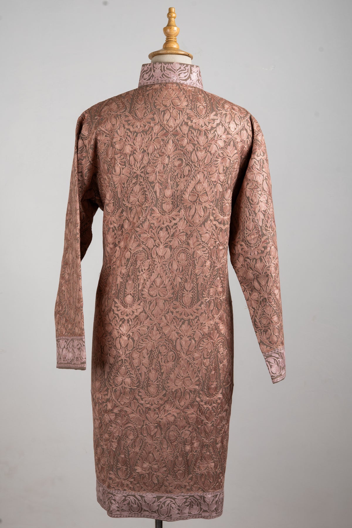 Full back view of a dusty-rose jacket with dense pale floral vines and broad embroidered collar, cuffs and hem
