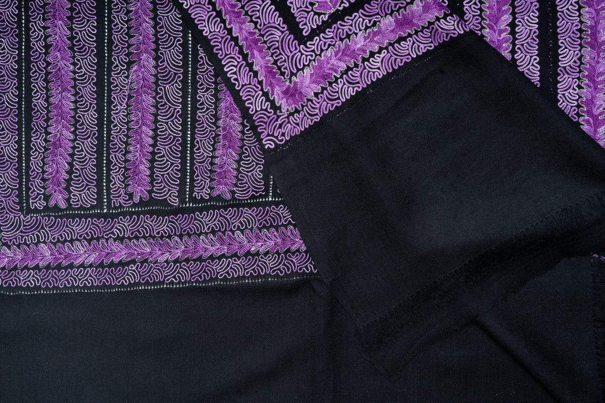 Folded charcoal stole showing overlapping embroidered corners, purple flower rows and broad plain end panels.