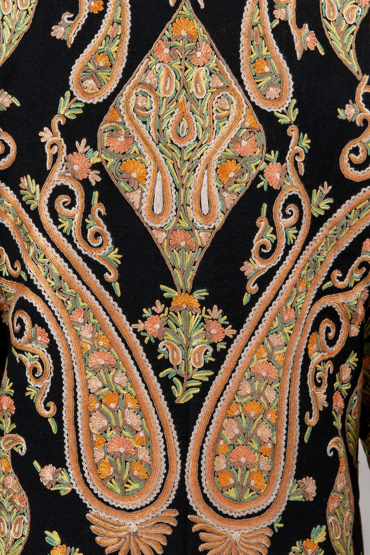 Close-up of the jacket’s back embroidery, showing paired peach paisleys around an olive-and-gold floral diamond motif