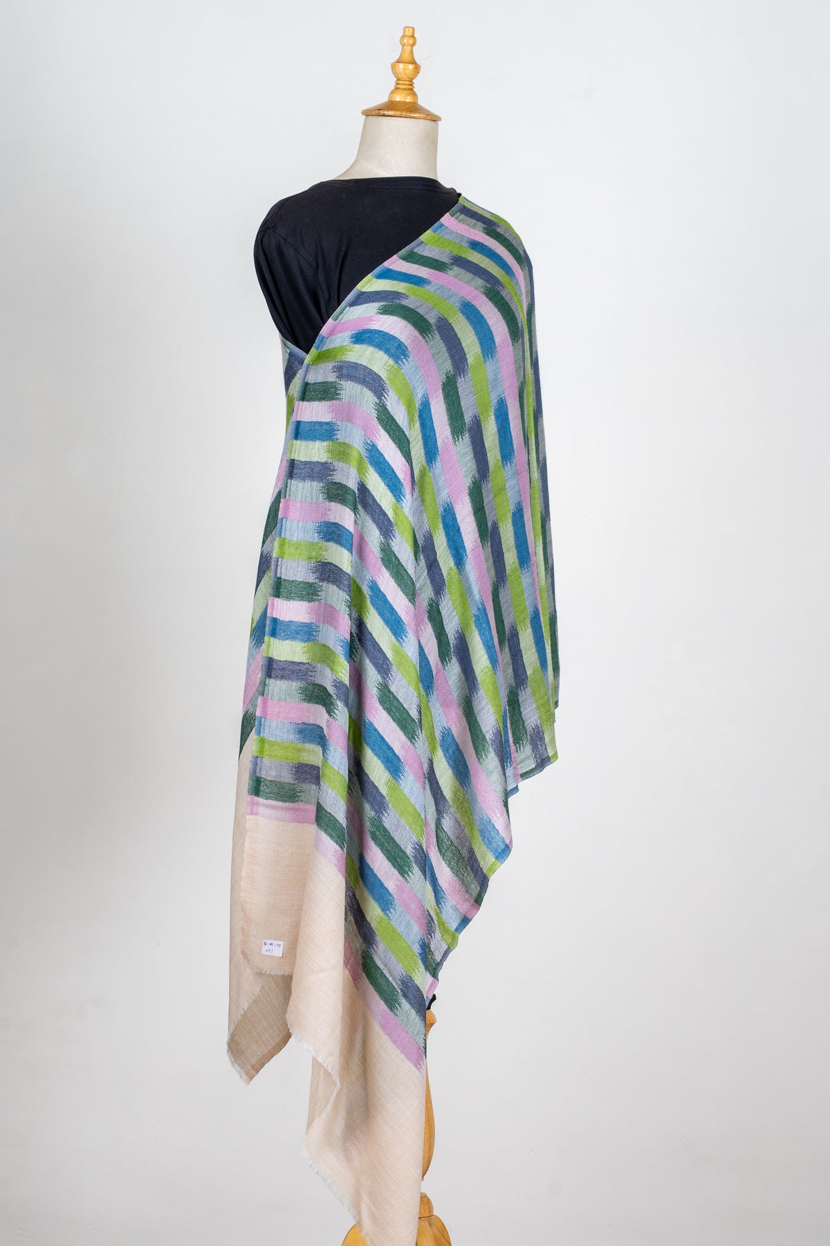 Full view of a printed Merino wool stole on a mannequin, with pink, blue, grey and green brush-like blocks and beige ends