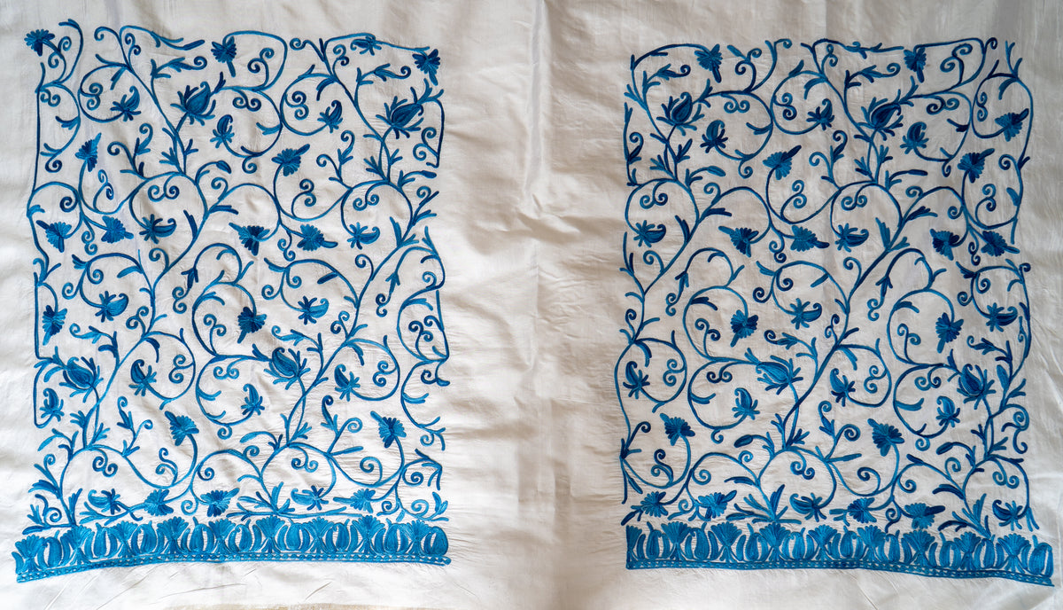 Two rectangular panels of blue Aari floral vines and leaf borders on ivory saree fabric