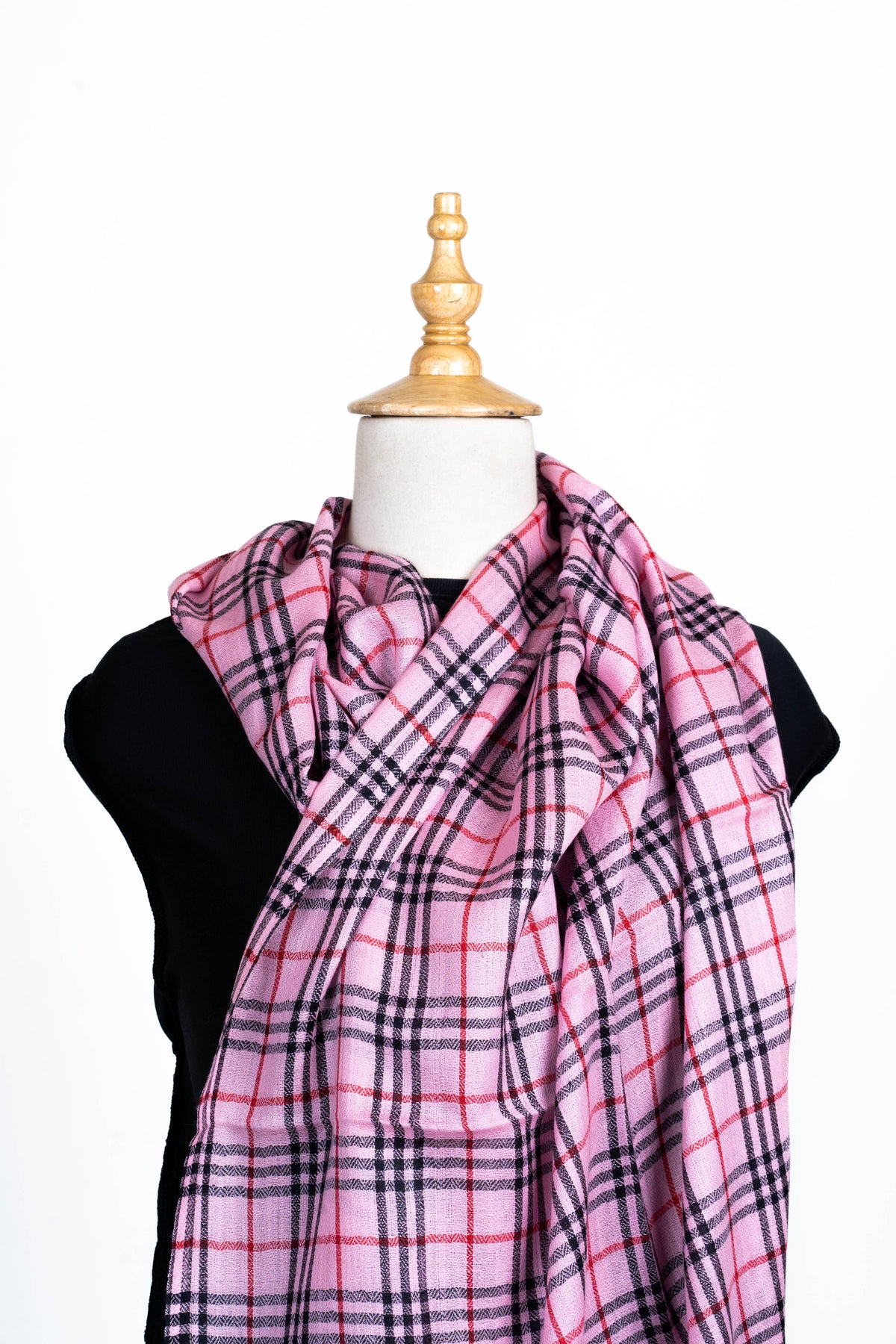 Pink checked Merino wool stole loosely crossed over a mannequin's chest, showing black and red grid lines