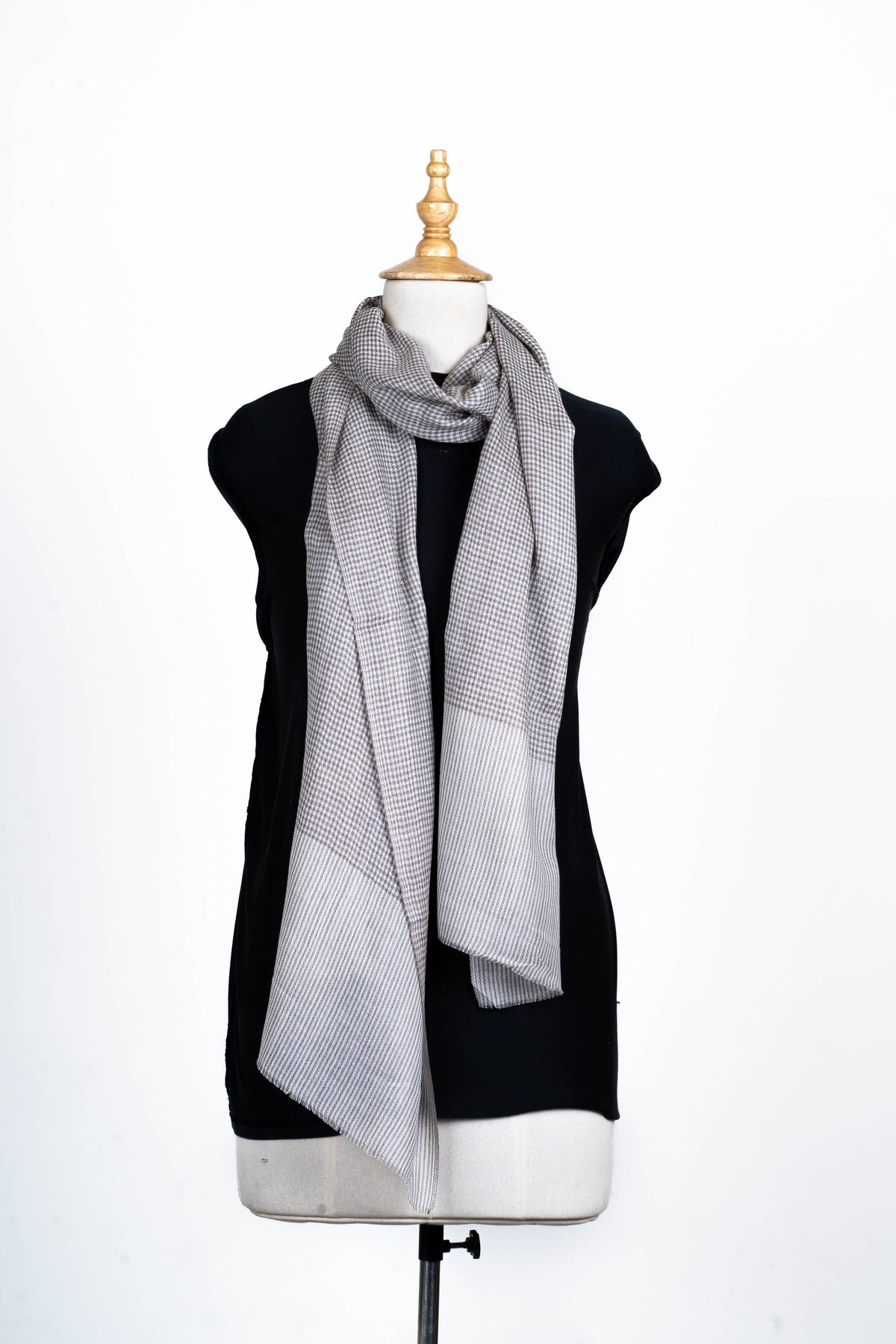 Full front view of the grey mini-check stole worn long around a mannequin neck, with pale striped end panels.