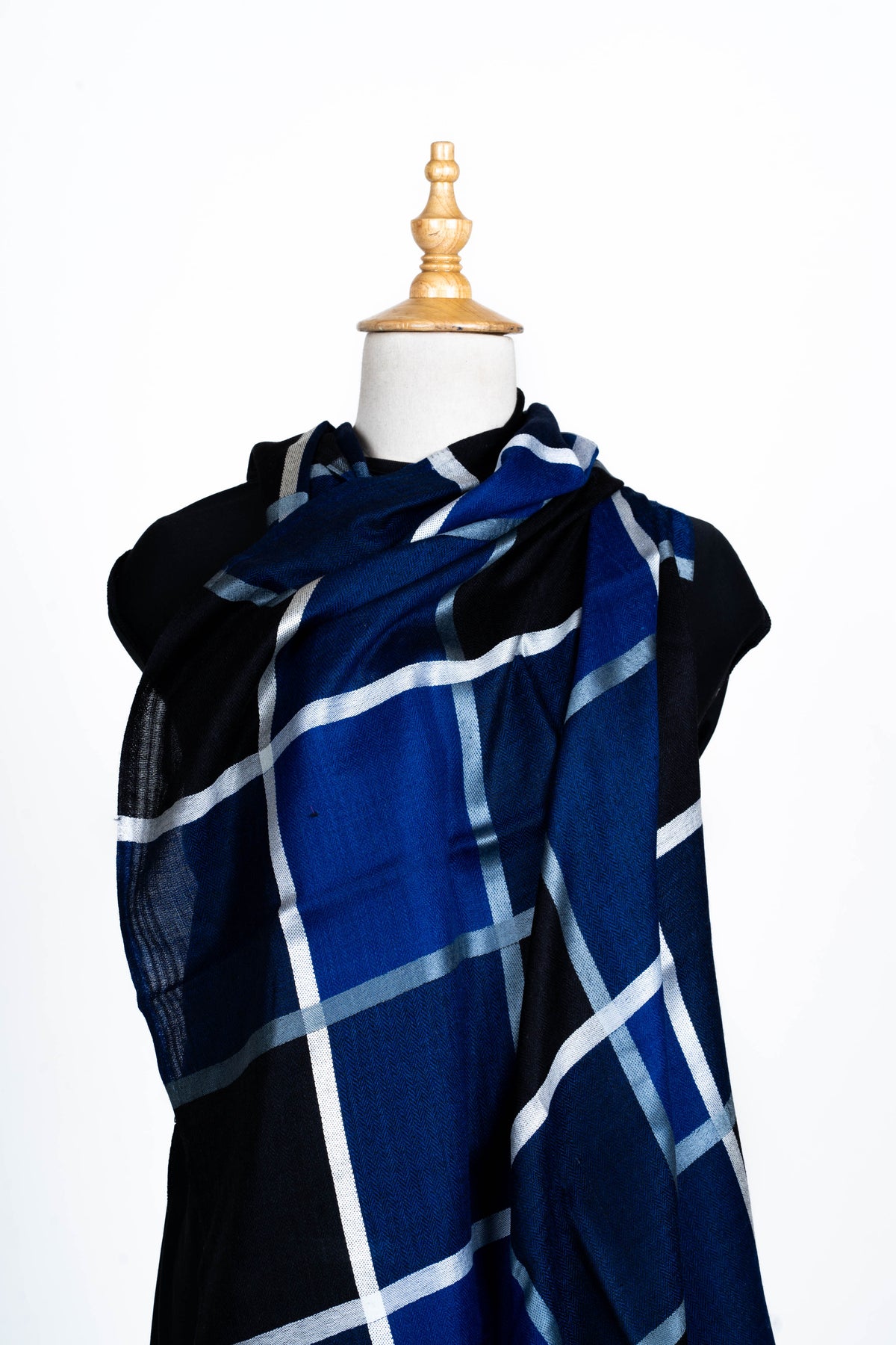 Navy and black Merino wool stole wrapped across a mannequin, displaying a large white windowpane pattern