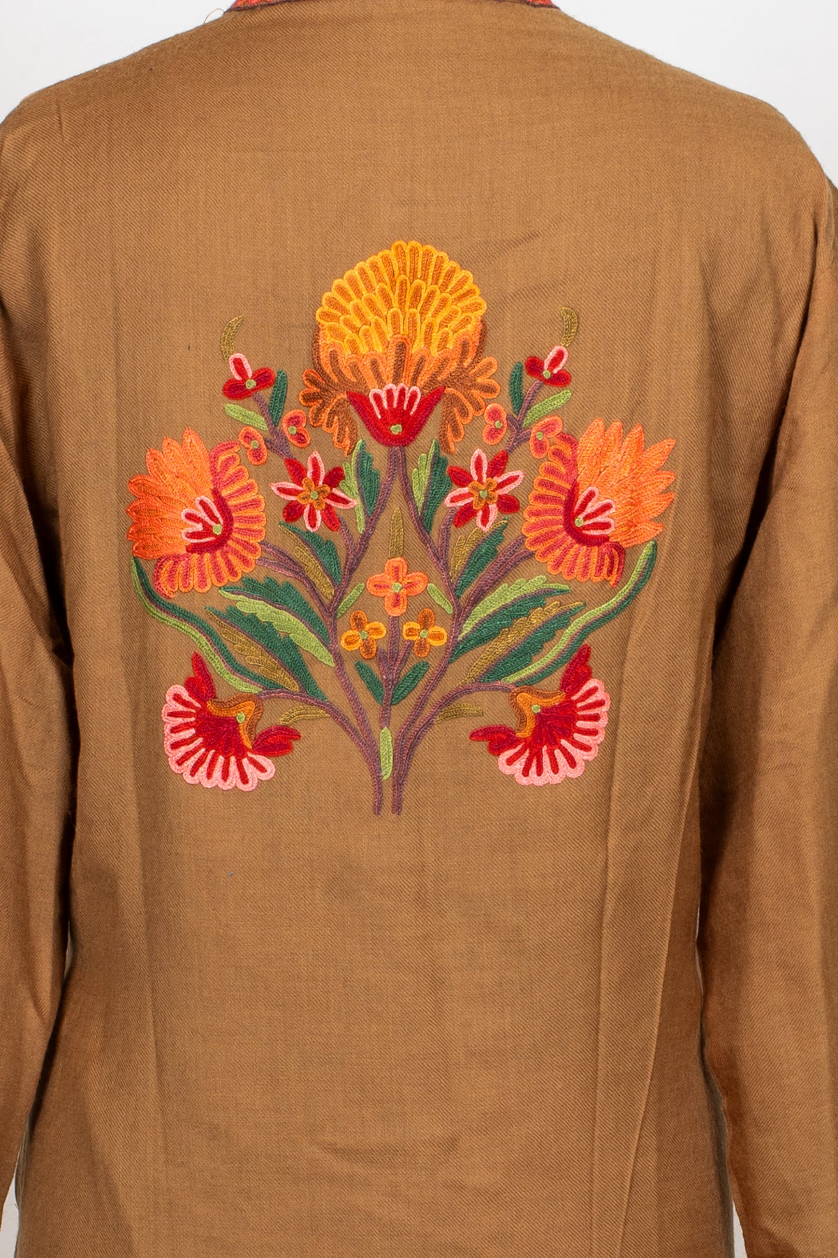 Close-up of the red, orange and yellow Hand Aari floral motif centred on the back of the earthy brown jacket