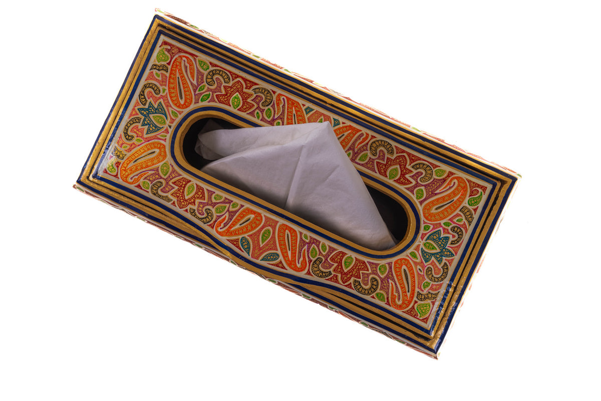 Tissue box viewed from above at an angle, showing orange paisleys, green leaves and striped blue-and-gold borders