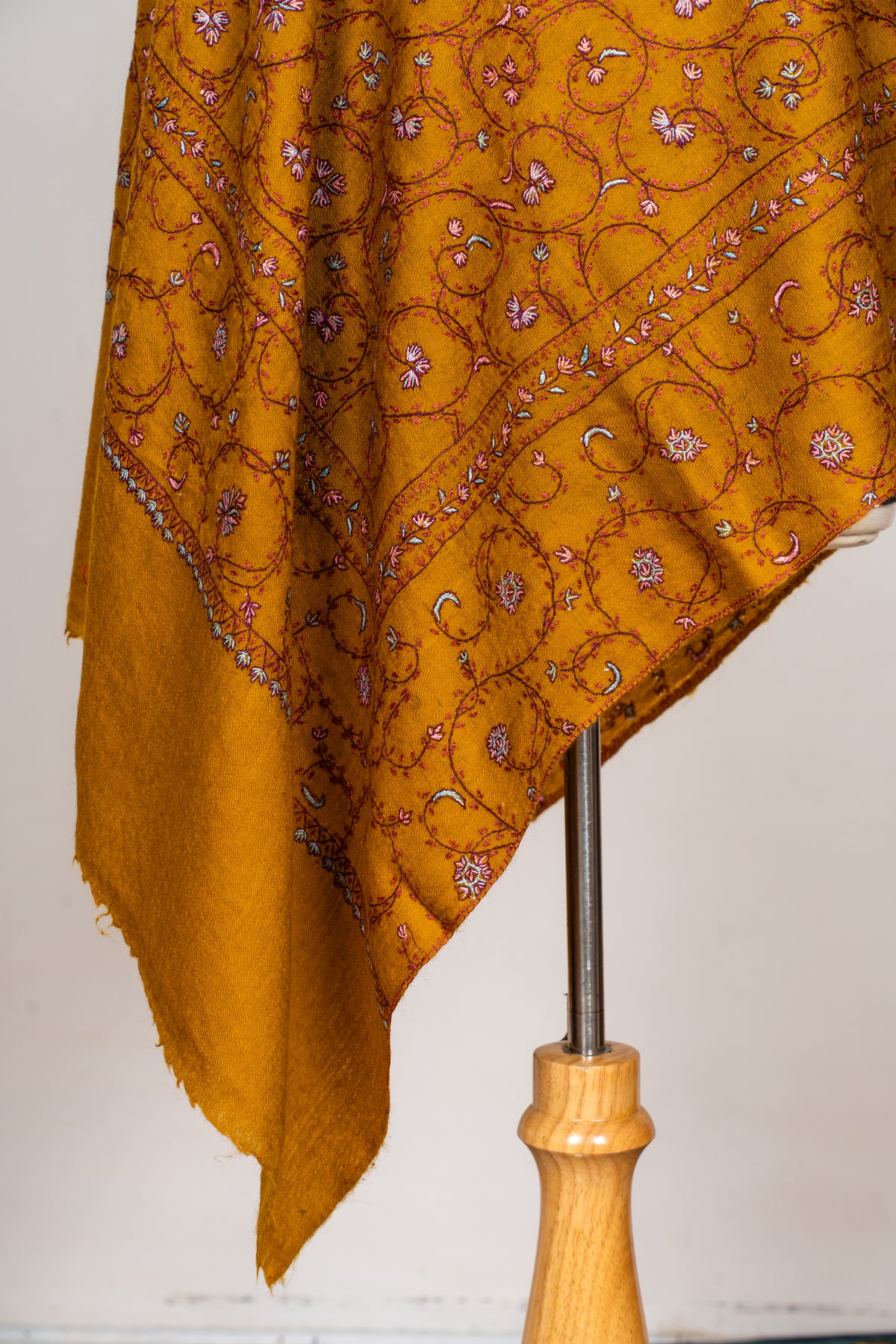 Draped mustard stole end with fine pink and white Sozni floral vines, narrow borders and plain fringed fabric
