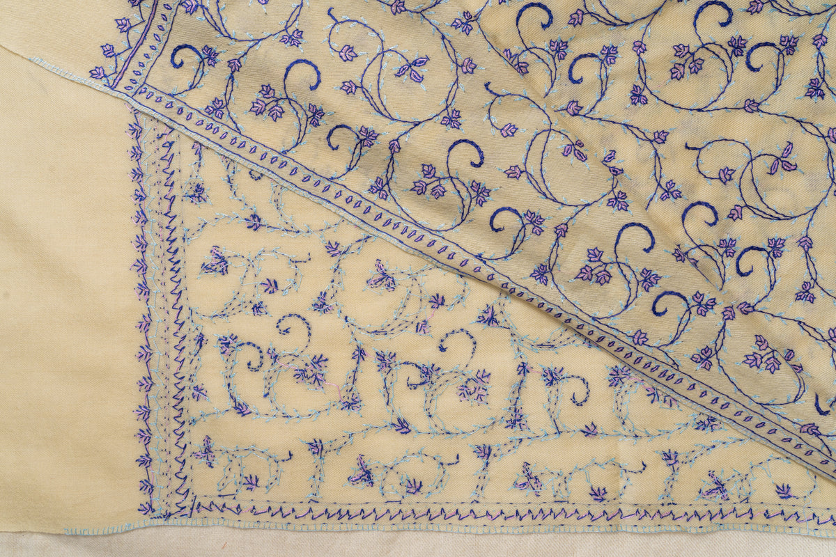 Cream stole folded diagonally to reveal the front and reverse of its purple floral vines and narrow embroidered edging