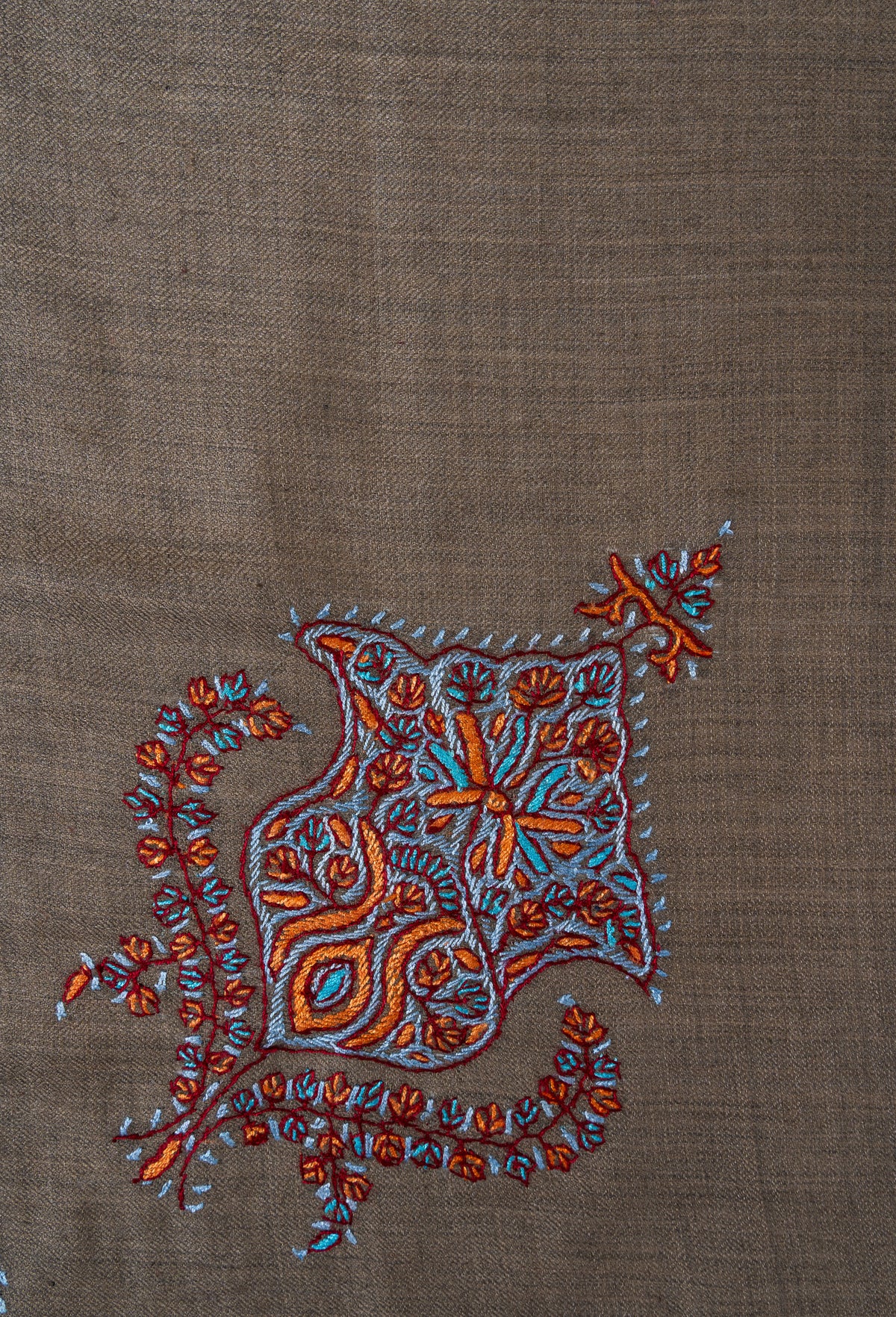 Small leaf-shaped Sozni floral motif in turquoise and copper with curved leafy sprays on a cedar-brown rumal