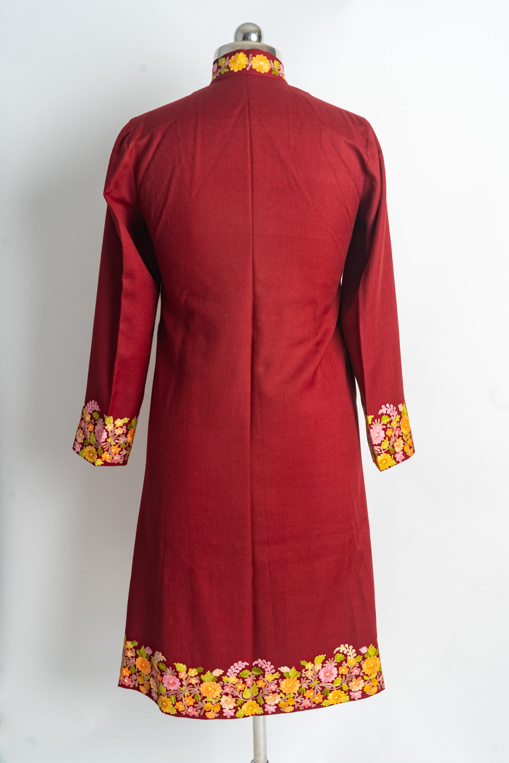 Back of the ruby-red long jacket with a plain centre and pink and yellow flower borders at the collar, cuffs and hem