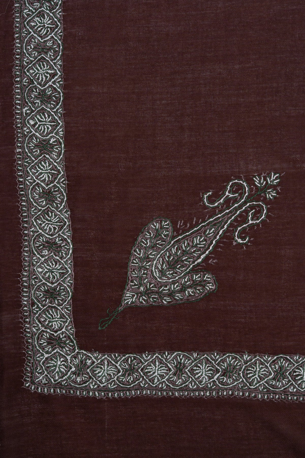 Chestnut-brown rumal corner with a silver-grey Sozni paisley inside a narrow geometric floral border
