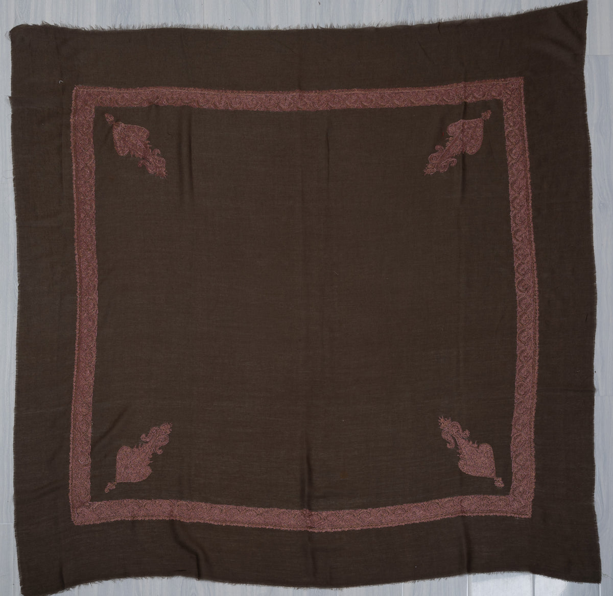 Dark brown square Merino wool rumal laid flat with rose-gold Sozni borders, four corner paisleys and a plain centre.