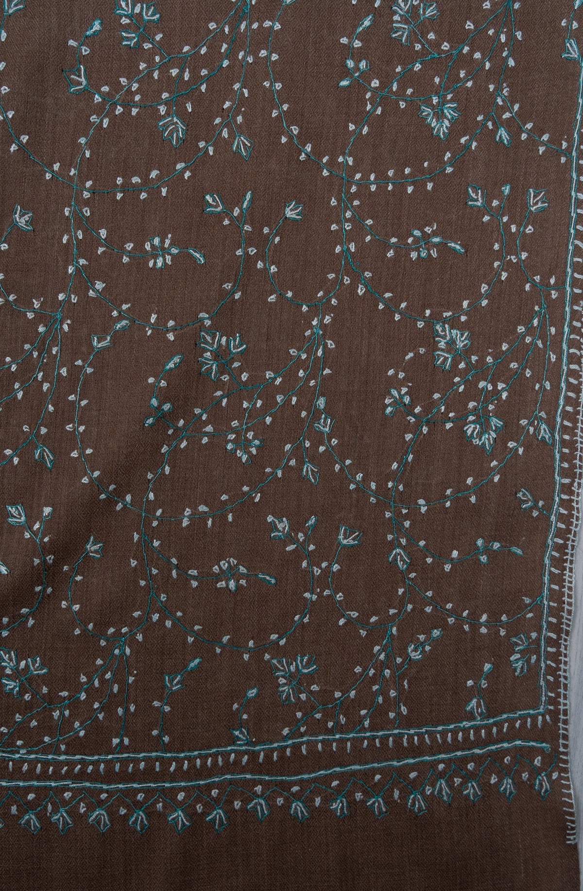 Cocoa-brown shawl corner with delicate pale aqua Sozni stems, small floral clusters and fine leaf edging