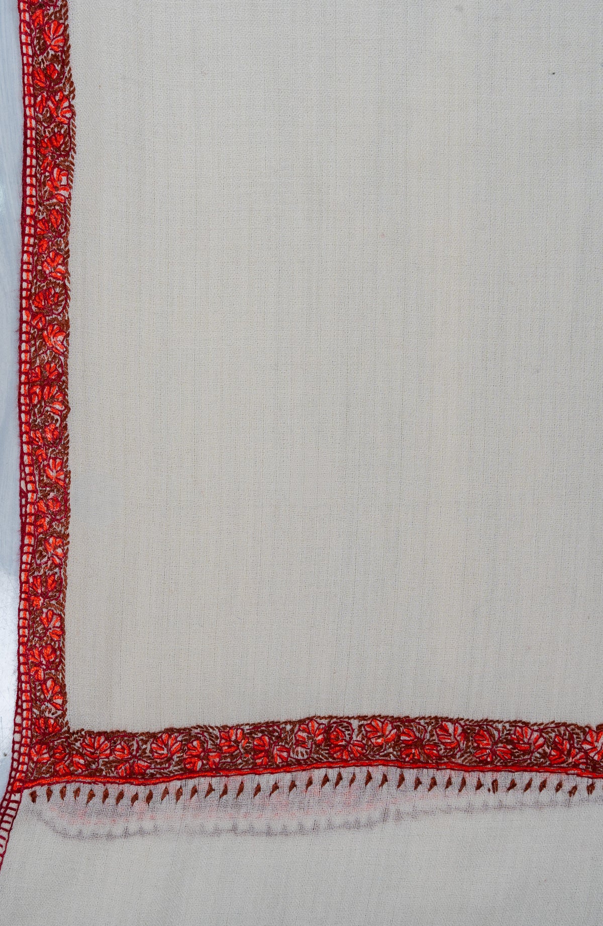 Ivory shawl corner with narrow ember-red Sozni floral borders meeting above small leaf edging