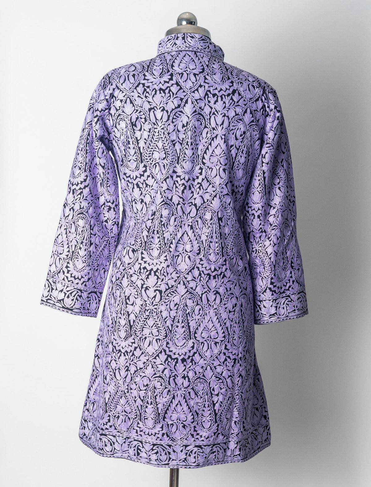 Back of the black wool jacket with dense pale lilac Aari paisleys and matching embroidered borders at the cuffs and hem.