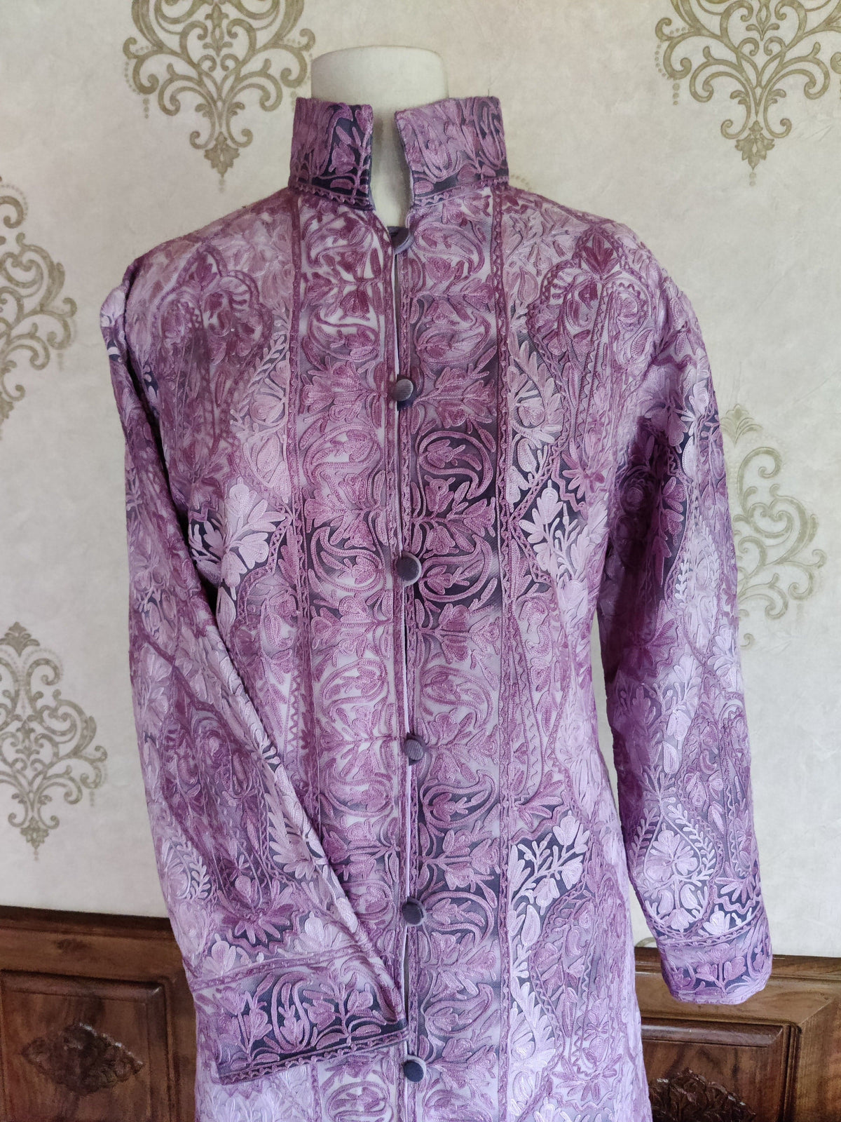 Front view of the purple tie-dye jacket showing large paisleys, dense floral embroidery and patterned cuffs.