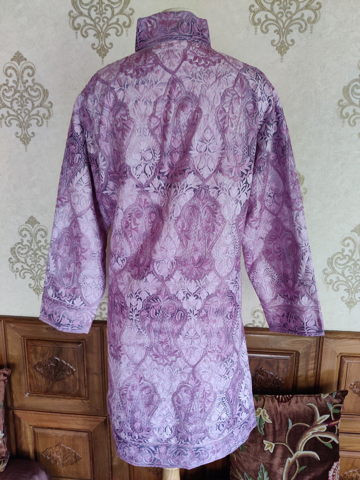 Back of a purple tie-dye jacket covered in large tonal paisleys and intricate floral vines.