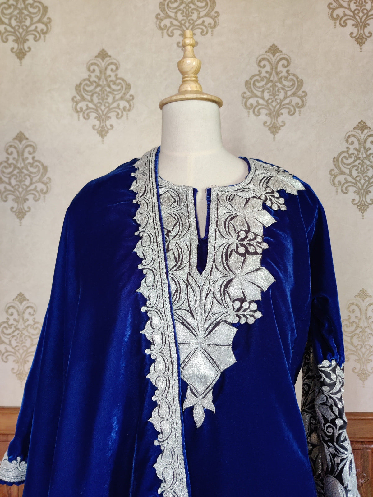 Upper view of the royal-blue velvet pheran and draped stole, showing the silver-toned neckline and narrow stole border.