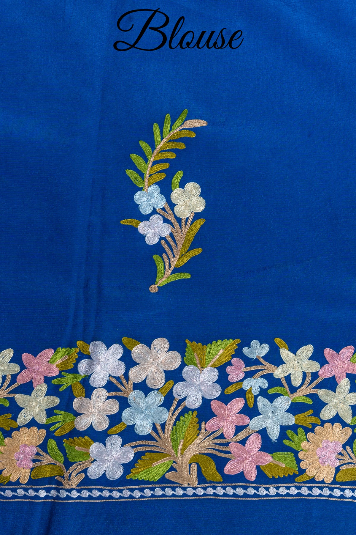 Royal blue blouse fabric with a pastel Aari flower sprig and a broad floral border, labelled Blouse
