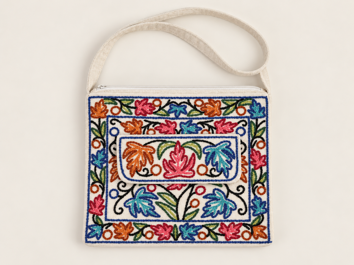 KashmKari embroidered cotton gift bag on a warm ivory surface