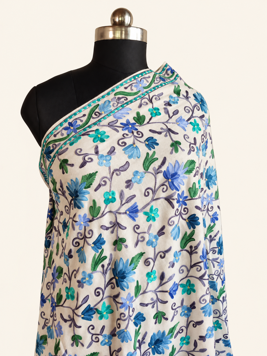 White fine Merino wool shawl with blue, turquoise and green floral Aari embroidery, alternate close draped studio view