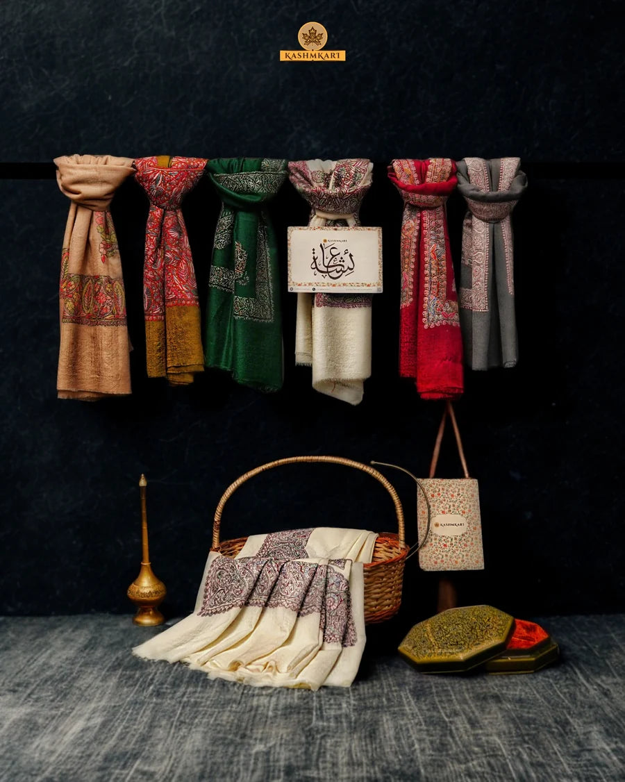 A selection of colourful embroidered shawls for men hanging from a rail