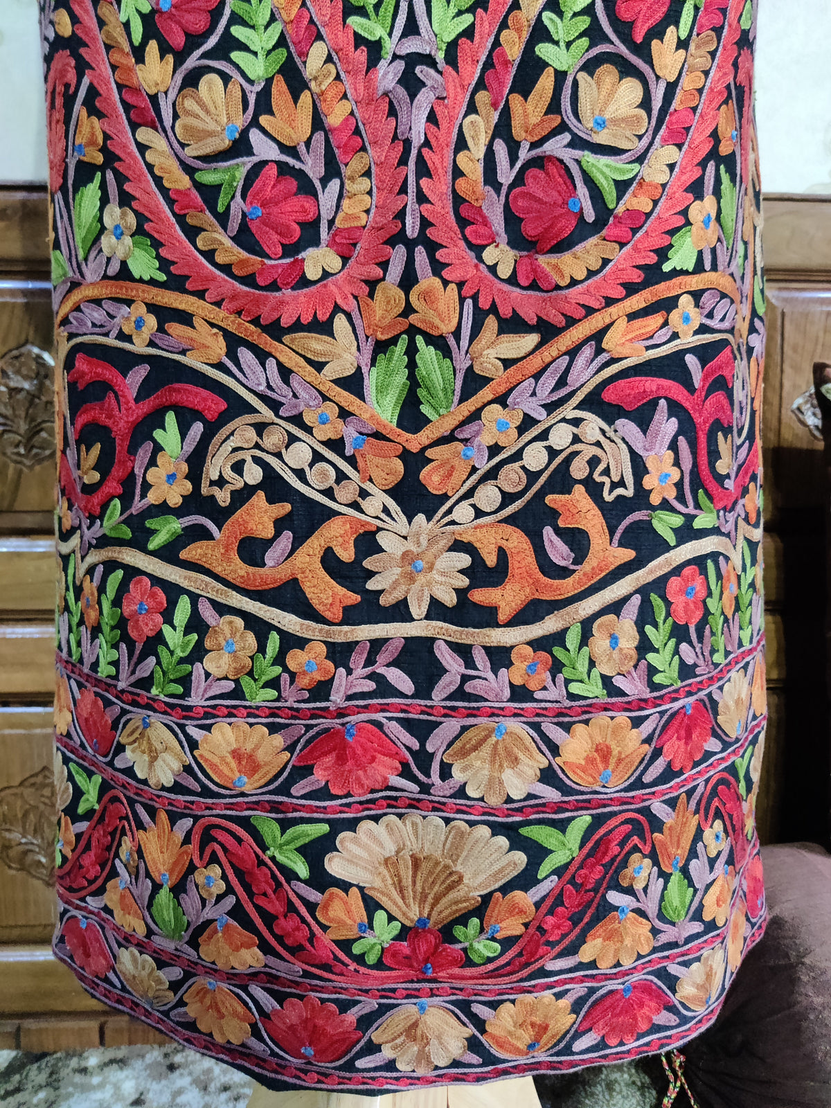 Detail of the jacket’s lower back, with large Aari paisley tips above stacked multicoloured floral borders.