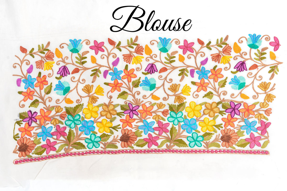 White fabric panel labelled “Blouse”, embroidered with multicoloured floral vines and a dense flower border.