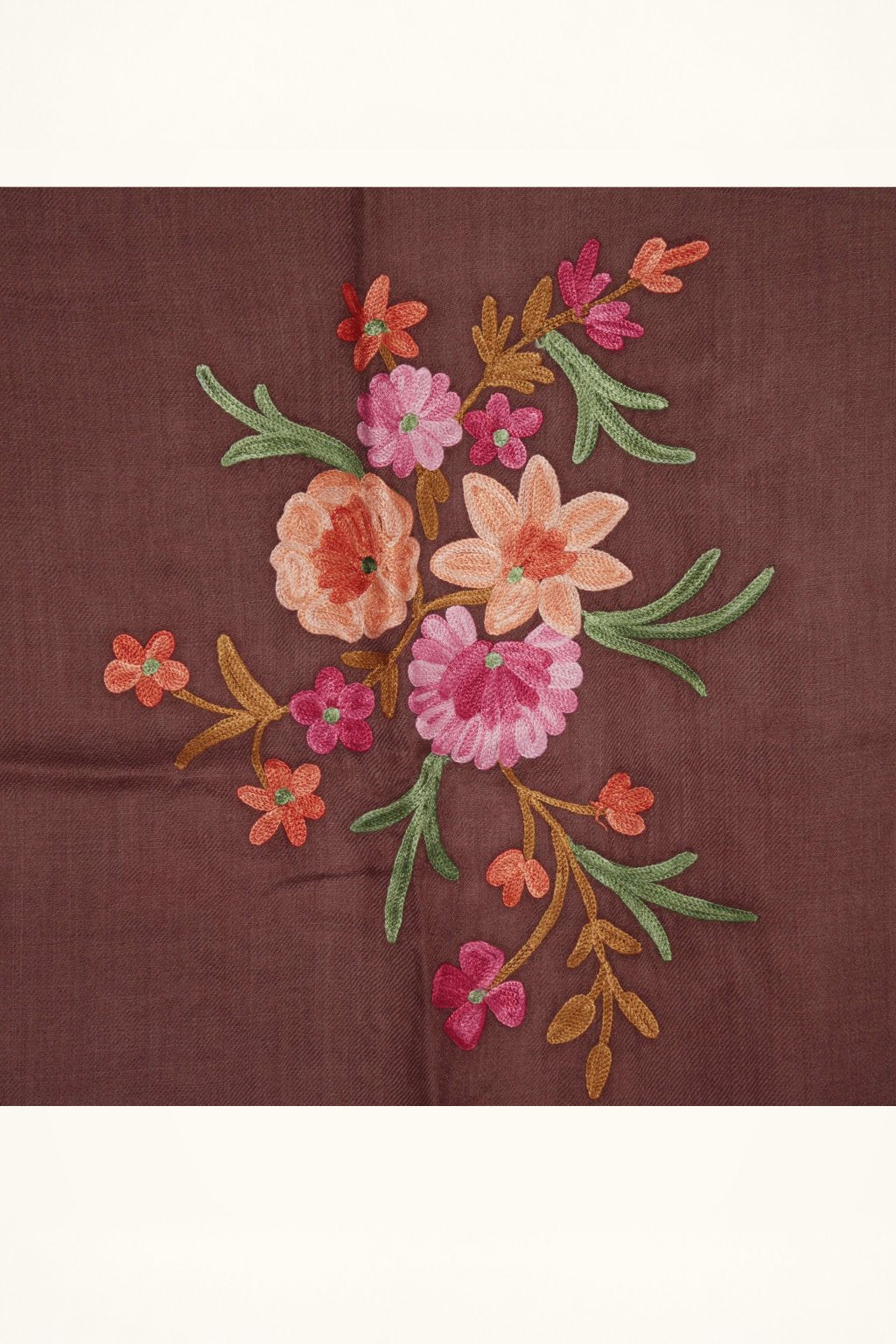 Close-up of pink, peach and orange Aari flowers with green leaves embroidered on a brown stole.