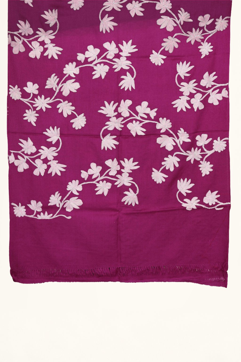 End detail of purple Merino wool scarf with ivory Aari floral vines above a plain purple strip and short fringe