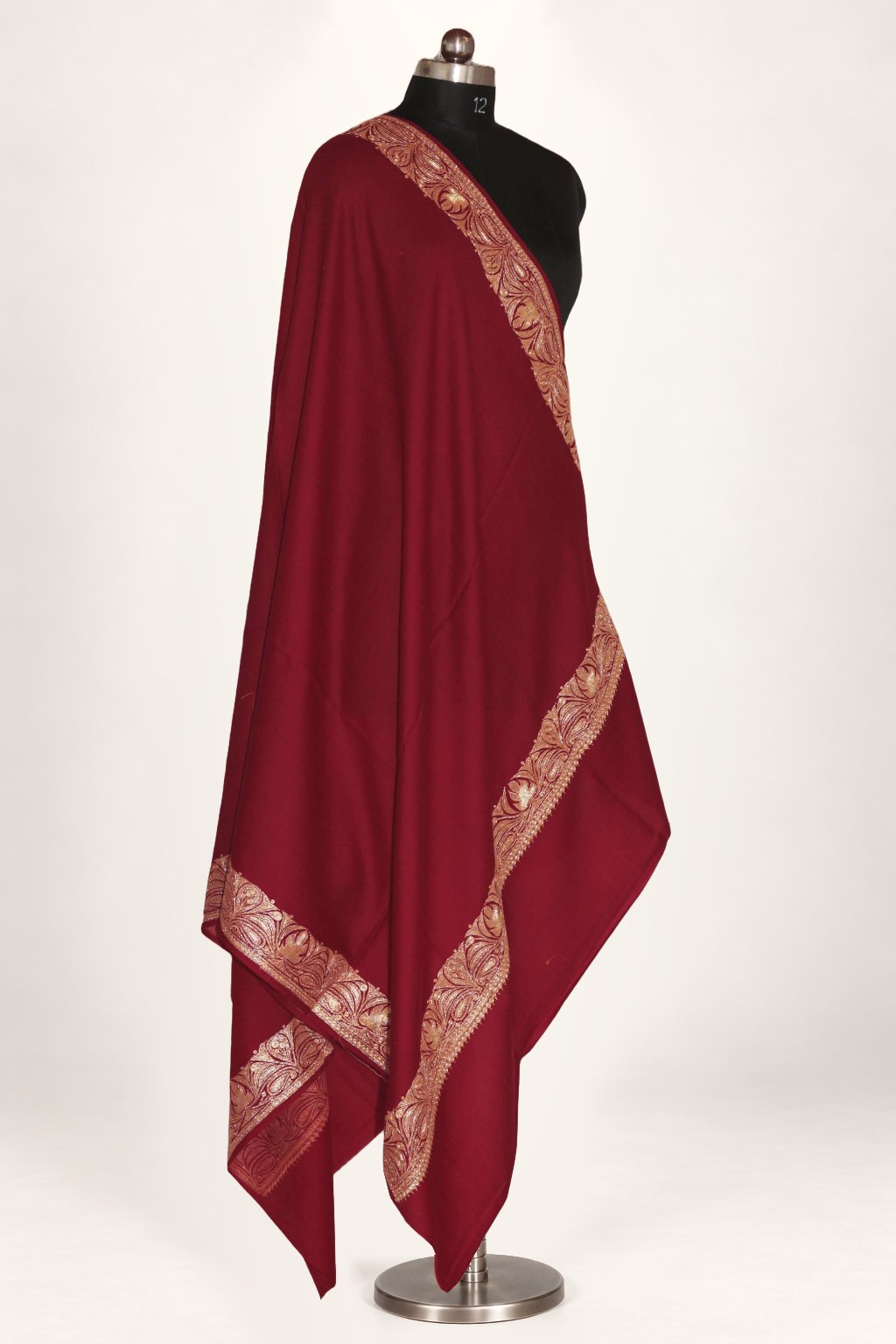 Maroon Merino wool shawl draped on a mannequin, with a golden Tilla leaf border around a plain centre