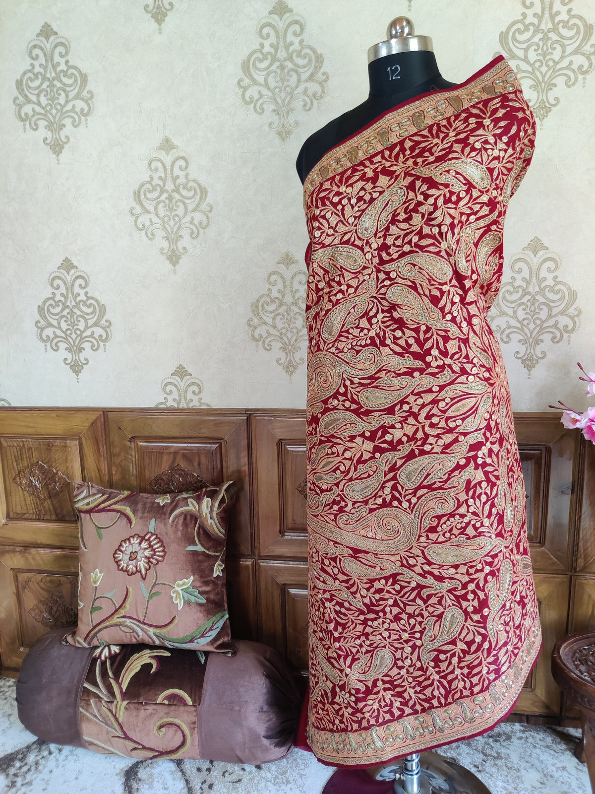 Full side view of a maroon Merino wool shawl wrapped around a mannequin, with dense Tilla paisleys and narrow metallic borders